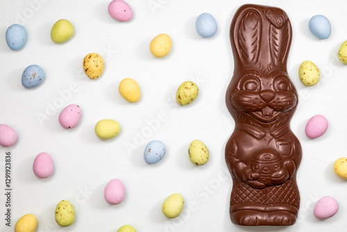 Obraz na płótnie Chocolate Easter bunny with mini eggs on white.
