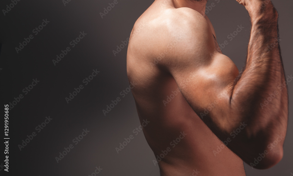 Fototapeta premium cropped image of strong male arm in studio