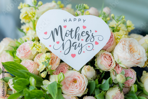 Amazing tender bouquet with pink ranunculus, violet Alstroemeria flowers and tiny white roses in cardboard box with pink ribbon. Beautiful bunch of spring flowers. Easter gift. Seasonal spring flowers
