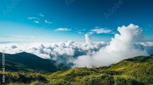 Peaceful mountain scene with a distant view from above the clouds, featuring a clear blue sky and fluffy white clouds. photo