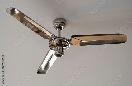 Shiny ceiling fan on light gray background. Seen from below