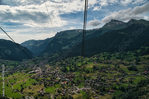 Views from a cable car from the village of Grindelwald in the Bernese Alps of Switzerland, known as the gateway to the Jungfrau. Landscape colorful meadows in spring, spectacular Swiss Alps. 