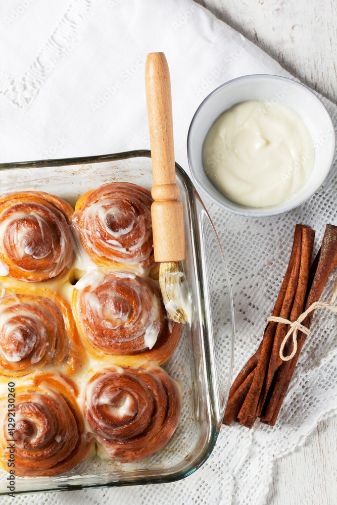 Cinnabons, cinnamon rolls topped with a cream of cream, cheese and sugar.