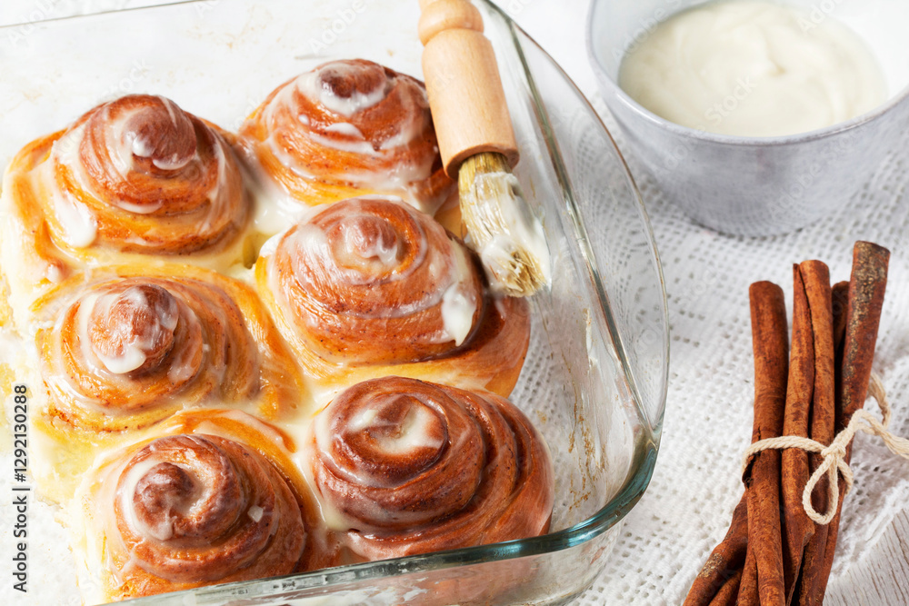 Cinnabons, cinnamon rolls topped with a cream of cream, cheese and sugar.