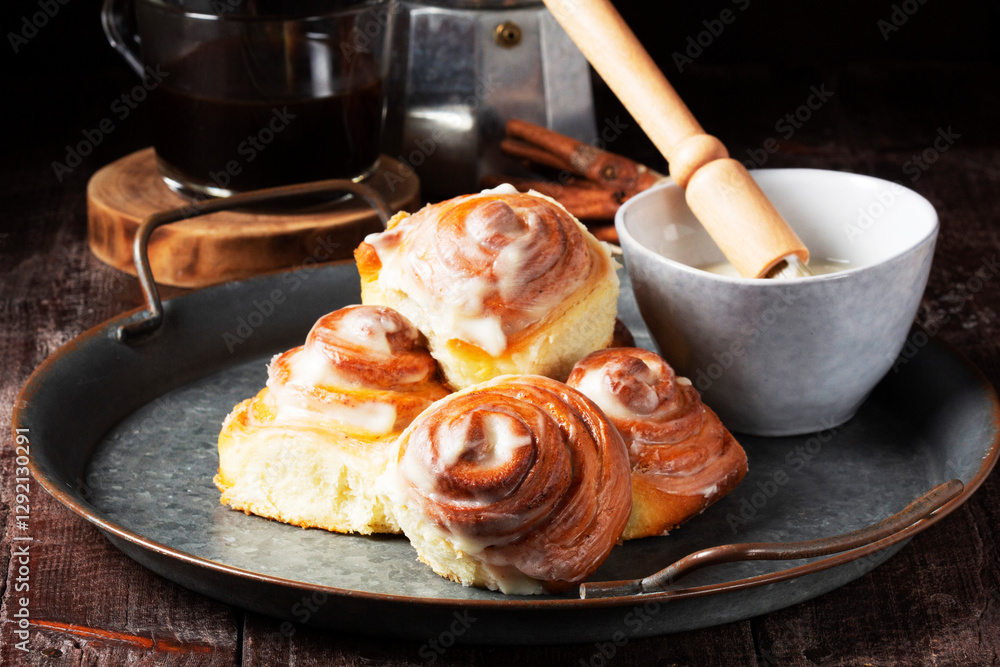 Cinnabons, cinnamon rolls topped with a cream of cream, cheese and sugar.
