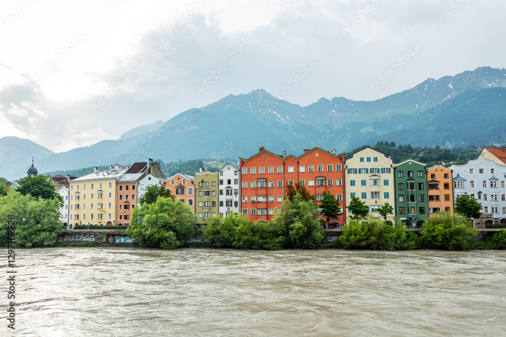 Innsbruck in cloudy day with sun, Austria town with colorful hou Innsbruck in cloudy day with sun, Austria town with colorful hou