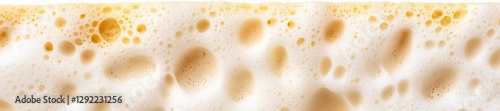 Frothy Creamy Beer Foam Close-Up on Vibrant Surface