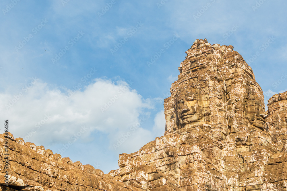 Fototapeta premium Ancient Bayon temple with carved smiling stone faces, Angkor Thom, Siem Reap, Cambodia