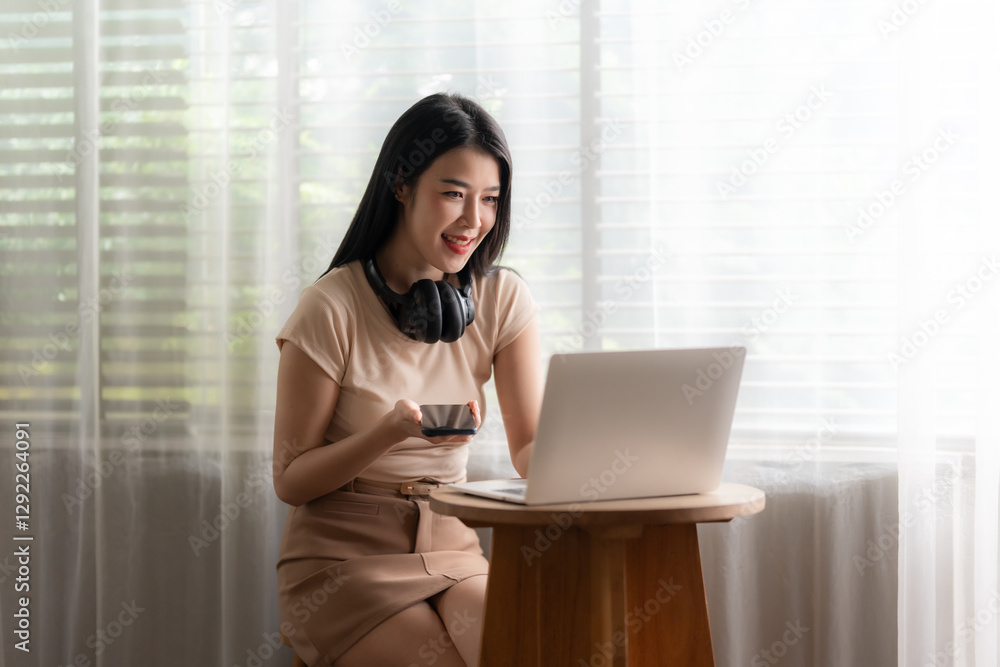 Joyful Remote Work: A young woman radiates joy as she works remotely, laptop in front of her, a cup of coffee in hand, headphones around her neck. Joyful Remote Work: A young woman radiates joy as she works remotely, laptop in front of her, a cup of coffee in hand, headphones around her neck.