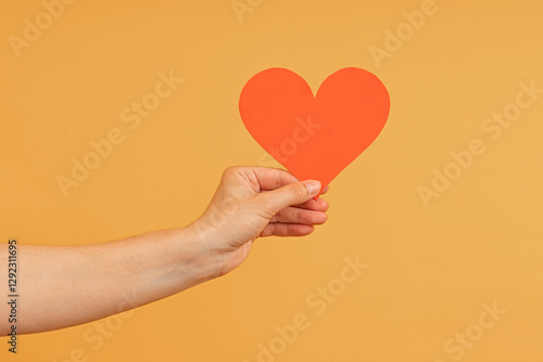 Foto A hand presenting an intact red paper heart