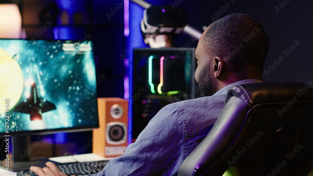 Fototapeta premium Gamer in neon lit apartment home shooting meteorites in spaceship flying singleplayer game on computer desktop. Player navigating galaxy, exploding enemies in simulation game on gaming PC, camera A