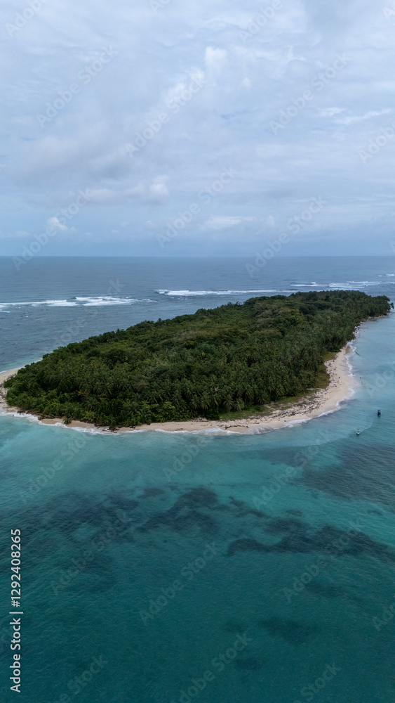 Aerial view of white waves coming to Cayo Zapatilla shore. Bocas del Toro archipelago, Panama, Caribbean, Central America. Aerial view of white waves coming to Cayo Zapatilla shore. Bocas del Toro archipelago, Panama, Caribbean, Central America.