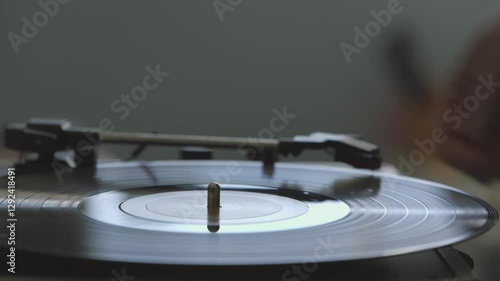 Close Up of Hands Putting a Vinyl Record on a Record Player With a Shallow Depth of Field