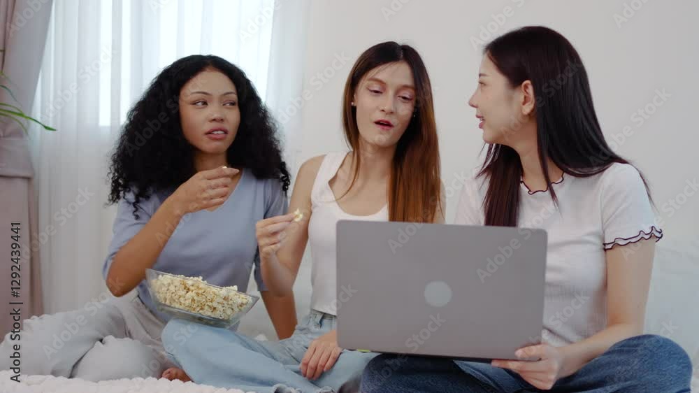 Three asian close friends woman relax on the bed, Girls is sharing popcorn and laughter as they browse the latest news on their laptops. A perfect afternoon filled with joy and connection in home Three asian close friends woman relax on the bed, Girls is sharing popcorn and laughter as they browse the latest news on their laptops. A perfect afternoon filled with joy and connection in home