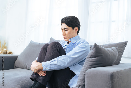 落ち込む、孤独、がっかり、失敗、呆然、引きこもり、男性、寂しい、憂鬱、うつ病、考える、悩む、悩み、困る、疑問、心配、不安、不満、トラブル、問題、憂うつ、ストレス、ノイローゼ、メンタルヘルス、残念、緊張、プレッシャー、疲労、過労、後悔、悔しい、ソファー、座る、インテリア、室内、部屋、ネガティブ、しょんぼり、挫折、若い、暗い、日本人、ライフスタイル、カジュアル、リビングルーム、仮病、コピースペース、イ