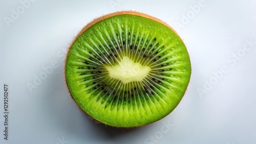 A vibrant, juicy kiwi fruit slice, showcasing its bright green flesh and tiny black seeds, rests against a clean, neutral backdrop.