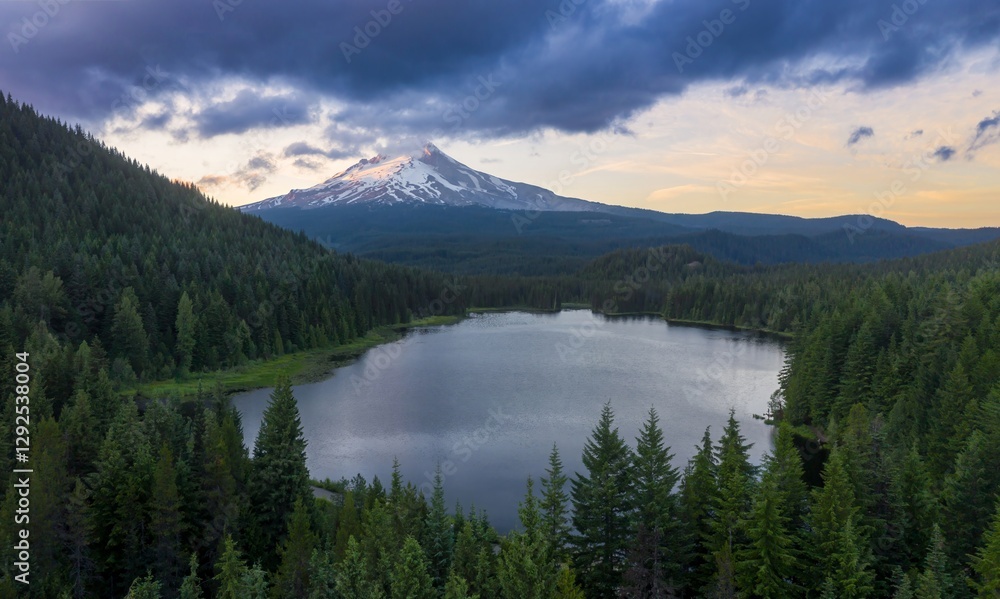 Majestic Mount Hood at dawn, reflected in a tranquil alpine Trillium Lake, surrounded by dark forest. Peaceful mountain scenery. Oregon, United States Majestic Mount Hood at dawn, reflected in a tranquil alpine Trillium Lake, surrounded by dark forest. Peaceful mountain scenery. Oregon, United States