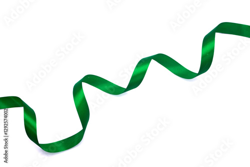 Delicate green wavy ribbon isolated on white background. Green ribbon satin confetti curly bow in jade emerald color (isolated with clipping path) on white background for holiday decoration element
