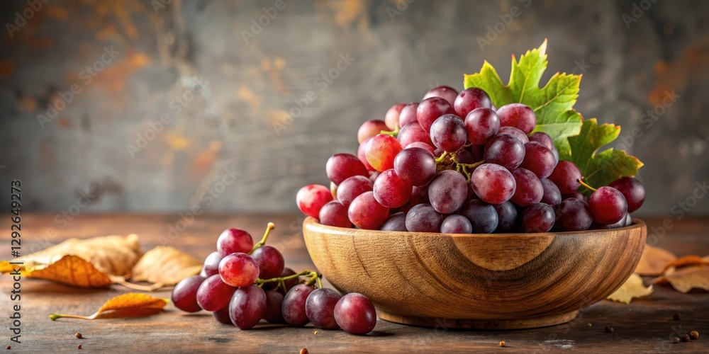 Freshly picked red grapes arranged artfully in a rustic wooden bowl, set against a neutral colored background, with some loose leaves scattered around the bowl , food, fruit Freshly picked red grapes arranged artfully in a rustic wooden bowl, set against a neutral colored background, with some loose leaves scattered around the bowl , food, fruit