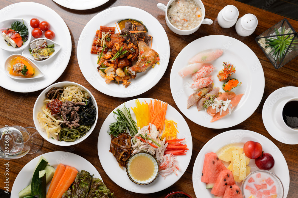 High angle view of assorted buffet food served on a white plate.
High angle view of assorted buffet food served on a white plate.