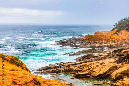 Overcast morning seascape with rocky headland at Bermagui photo