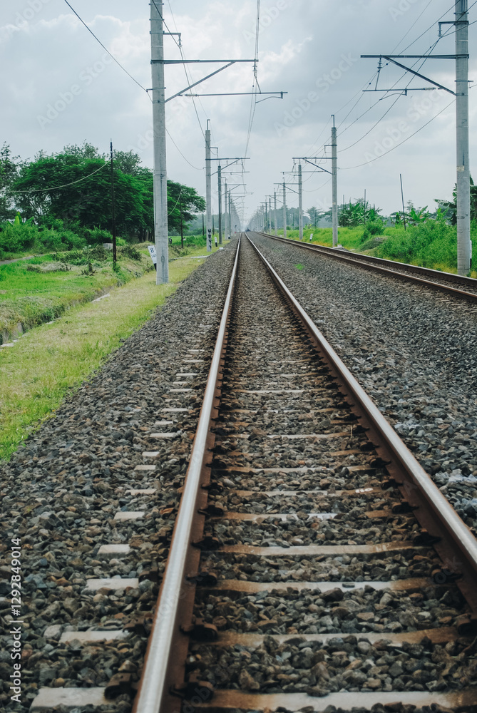 Railway tracks crossing green rice fields, Klaten, Central Java, Indonesia Railway tracks crossing green rice fields, Klaten, Central Java, Indonesia
