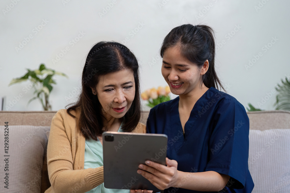 Caregiver and patient reviewing health information on a tablet, showcasing teamwork in healthcare. Caregiver and patient reviewing health information on a tablet, showcasing teamwork in healthcare.