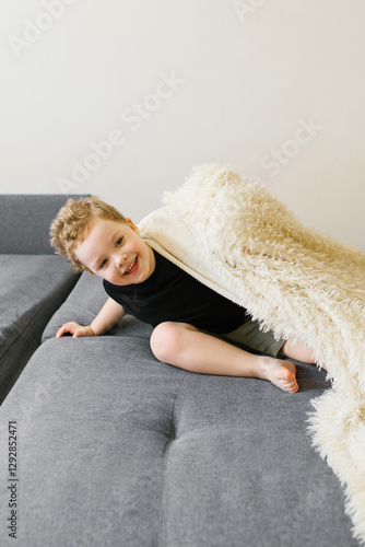 Boy Hiding Under A White Blanket