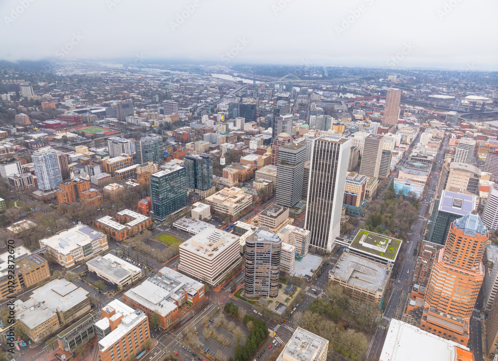 Fototapeta premium A city view from above with tall buildings and a river in the background
