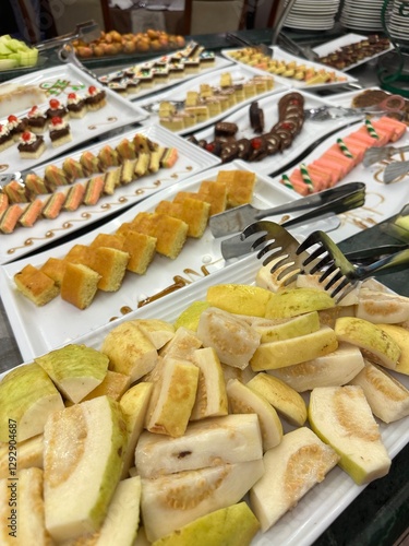 Variety of cakes as dessert and guava on display on a Nile cruise, Egypt