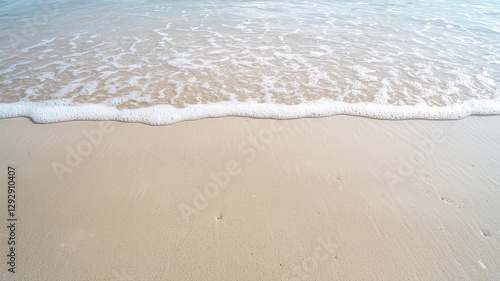 Peaceful beach scene with gentle waves lapping onto smooth sand, evoking tranquility and relaxation.