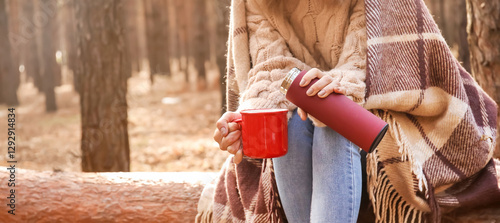 Young woman with thermos dr...