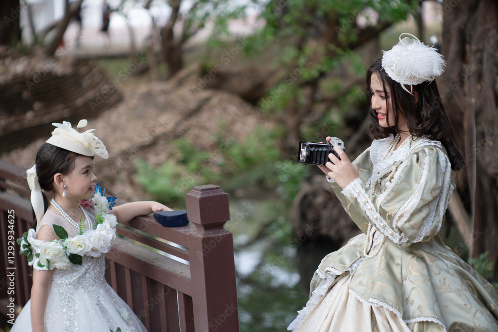 Two sister wearing vintage clothes are having fun happily in a large garden house.