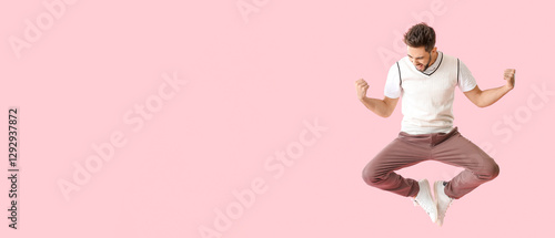 Jumping young man on color ...