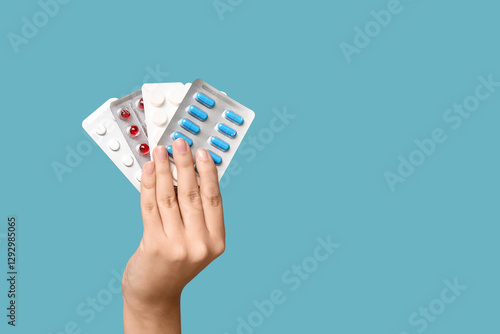 Female hand holding pills i...