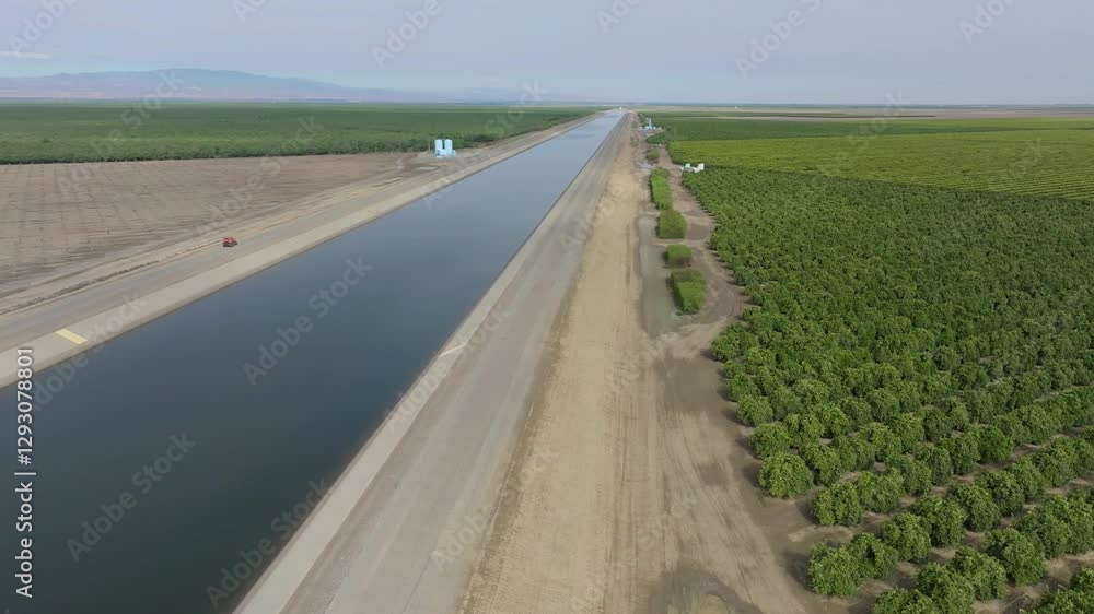 ATV running along California aqueduct canal in farmland ATV running along California aqueduct canal in farmland