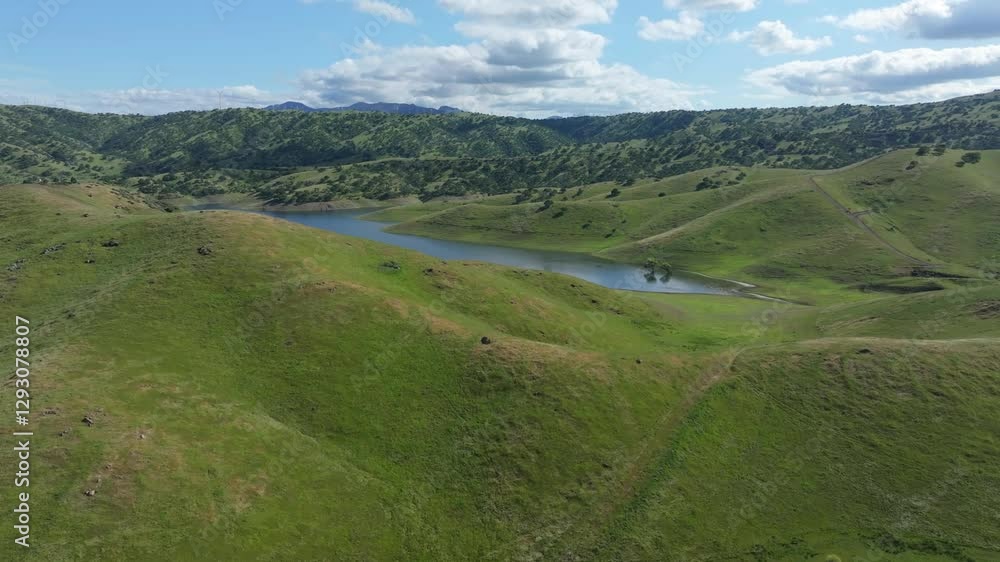 Green rolling hills surrounding blue water San Luis Reservoir Green rolling hills surrounding blue water San Luis Reservoir
