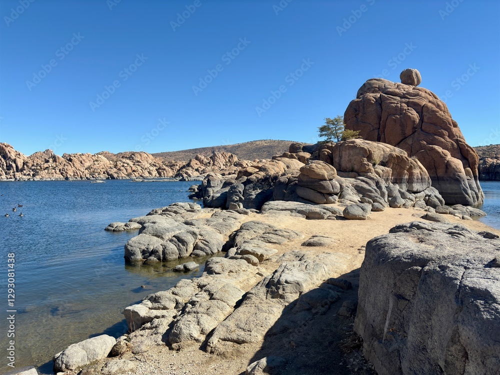 Rocky shoreline of Watson Lake in Prescott, AZ, with calm blue water Rocky shoreline of Watson Lake in Prescott, AZ, with calm blue water