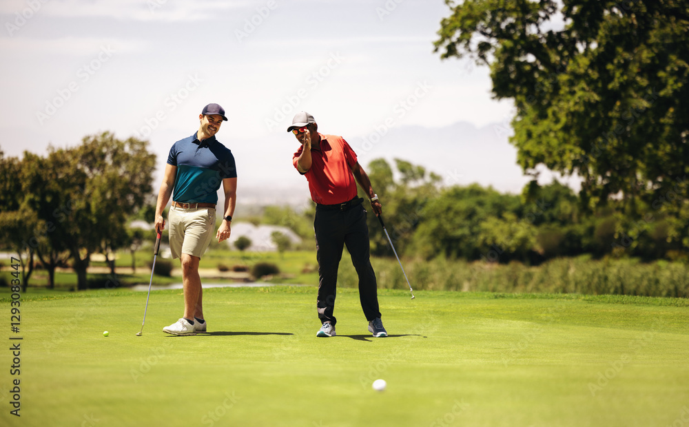 Fototapeta premium Two sportsmen at a golf resort planning the perfect shot