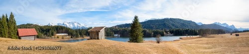 wide panorama landscape lake Geroldsee, meadow with huts, view to Wetterstein and Karwendel mountains photo