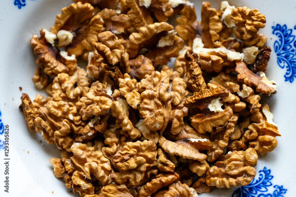Walnuts arranged on a decorative plate for healthy snacking Walnuts arranged on a decorative plate for healthy snacking