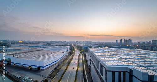 Photos Aerial view of modern industrial park and cityscape at sunset