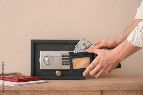 Man putting money from wall...