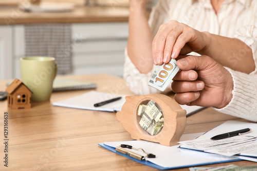 Senior couple putting money...