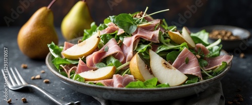 Fresh Salad with Ham and Pear on a Decorative Plate Perfect for Restaurant Menus and Culinary Presentations in Studio Lighting photo