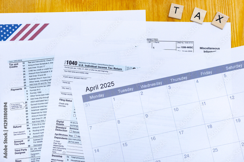 Tax documents, IRS forms, and calendar for April 2025 on a wooden desk Tax documents, IRS forms, and calendar for April 2025 on a wooden desk