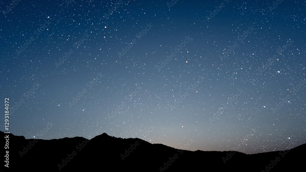 A movement of stars in the night sky with the view of mountains.. A movement of stars in the night sky with the view of mountains..