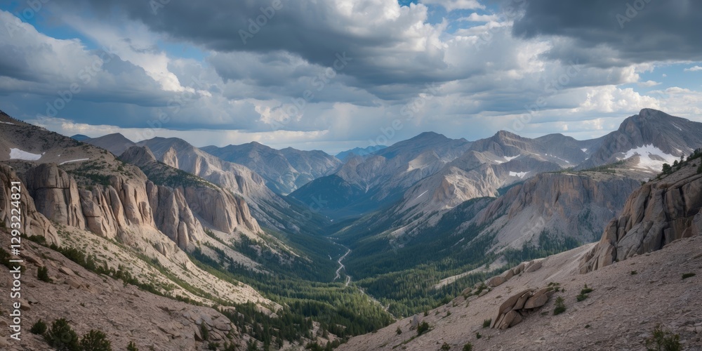 Fototapeta premium Panoramic View of Rocky Mountain Valley Under Dramatic Cloudy Sky with Lush Greenery and Space for Text or Graphics