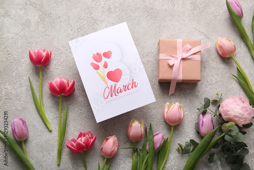 Greeting card with beautiful tulip flowers and gift box on grey background. International Women's Day celebration