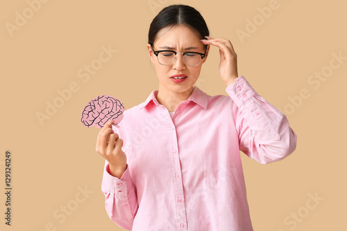 Young Asian woman with pape...